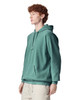 A teal adult hooded sweatshirt with a front pocket and a drawstring hood displayed on a model.