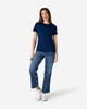 A navy blue ladies' T-shirt paired with light blue jeans and white sneakers. The shirt features a logo.