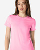 A pink Gildan Softstyle ladies' t-shirt displayed on a model, featuring a round neckline and short sleeves.