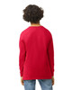 A red long sleeve youth t-shirt viewed from the back, featuring a simple design and relaxed fit.