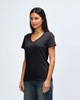 A black Gildan Softstyle ladies' V-neck T-shirt displayed on a model, paired with blue jeans.