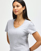 A light grey ladies' V-neck t-shirt displayed on a model, featuring a fitted silhouette and short sleeves.