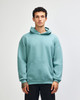 A unisex hooded sweatshirt in mint green with a front pocket and a brand logo.