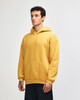 A unisex hooded sweatshirt in mustard yellow with a kangaroo pocket and a logo.