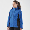 A blue and black women's jacket with a hood, featuring a logo on the sleeve.