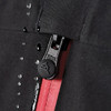 A close-up of a black softshell jacket featuring a zip closure and a red interior. The jacket includes a logo detail.