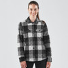 A women's black and grey plaid shacket with a button-up front and two chest pockets, featuring a logo.