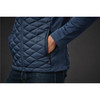 A men's thermal shell jacket in navy blue featuring a quilted design and side pockets. The model's hand is in a pocket.