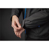 A black rain jacket featuring blue accents, focusing on a hand adjusting the cuff. It includes a logo.