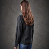 A black button-up shirt with long sleeves, seen from the back, worn by a woman with long hair.