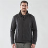 A black men's jacket with a collared design, featuring buttons and a logo. The model stands against a plain background.