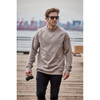 Men's Monashee fleece crew neck sweater in beige, worn by a man holding a camera, set against an outdoor background.