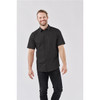 A short-sleeved black button-up shirt worn by a smiling man, featuring a simple design and a logo on the chest.