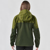 A woman wearing a dark green jacket with a hood, seen from the back. The jacket features a logo.