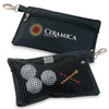 A black microfibre accessories bag with a logo, featuring a zippered compartment and a mesh side holding golf balls and tees.