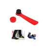 A red shoe horn with a brush cap. The brush is black and the horn is smooth. Includes a container for storage.
