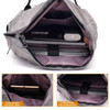 A grey laptop backpack with multiple compartments, including sections for laptops and small items.