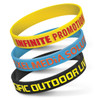 Four silicone wristbands in various colors—yellow, blue, and black—each embossed with different promotional messages.
