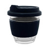 A reusable glass coffee cup with a black silicone sleeve and lid, featuring a clear glass body.