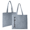 A grey felt tote bag with long handles and a logo on one side.
