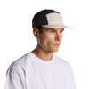 A two-tone nylon cap in black and cream, featuring a curved brim and a logo on the side.