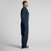 A navy canvas coverall featuring a zip front and side pockets, presented in a side view.