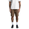 Cotton cargo shorts in a light brown colour, featuring multiple pockets, worn by a person with tattoos.
