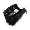 A black toiletry bag with compartments containing cables, a travel adapter, and other accessories.