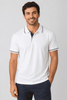 A polo shirt in white with navy accents, featuring a collared neck and a branded logo.