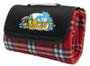 A red check picnic rug folded with a black carrying strap and featuring a logo on the front.