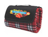 A red check picnic rug with a black flap and a logo of assorted fruits on the front.