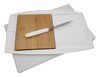 A white Jumbo Party Plate with a bamboo cutting board and a metal knife, set against a plain background.
