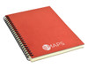A red A5 notebook with a spiral binding and a logo on the cover.