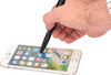 A black 6-in-1 multi pen being used as a stylus on a smartphone screen, featuring a hand and a mobile device.