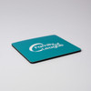 A teal coaster with a black edge features a logo on its surface.