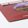 A magnetic photo frame in maroon, featuring a circular cut-out for displaying a photo, with a branding logo.