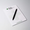 A5 notepad with 25 leaves, featuring a white background and a black pen, includes a logo at the top.