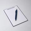 A5 notepad with 50 lined leaves, featuring a blue cover and a silver pen placed on top. It has a logo at the top.