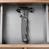 A black survival hammer with multiple tools, displayed in a grey drawer. It features a sleek design and a branding logo.