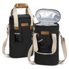 A wine cooler bag in black with tan leather accents, featuring handles and an insulated interior.
