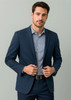 A navy men's blazer jacket worn over a light blue checkered shirt, featuring a subtle logo.
