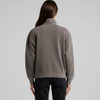 A faded grey half zip jacket with a relaxed fit and long sleeves, featuring a collar and a visible logo.