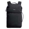 A black backpack with shoulder straps, featuring a front pocket and a logo on the exterior.