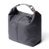 A grey cooler bag with a minimalist design, featuring a top handle and a zip closure, alongside a branding logo.
