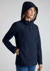 A women's navy jacket with a hood and zip-front closure, featuring a branded logo on the sleeve.