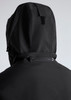A black women's jacket with a hood, featuring a zippered pocket and a textured fabric design.