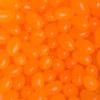 A close-up of bright orange jelly beans in various shapes and sizes, glossy and eye-catching in appearance.