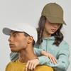 Two people wearing caps; one in white and the other in olive green, against a neutral background.
