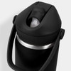 A drink bottle in black with a flip straw and metal trim, featuring a handle and a logo.