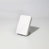 A white wireless charging power bank with a circular charging area and a subtle logo.